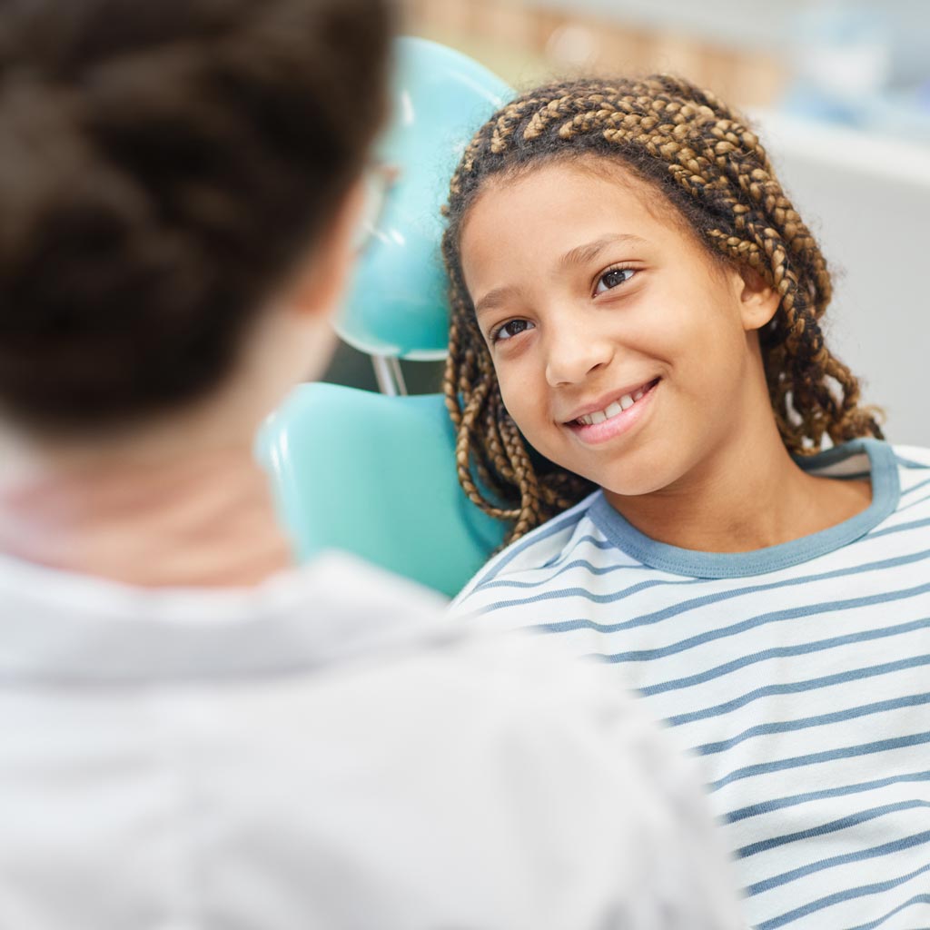 Smiling teen girl in dental chair