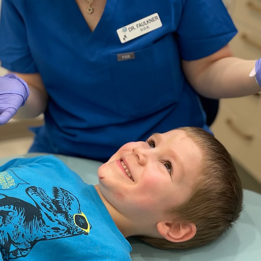 Smiling mom and daughter in dental chair